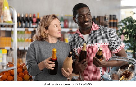 Married couple choose wine and beer together for a holiday party at a grocery store