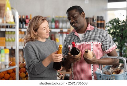 Married couple choose wine together for a holiday party at a grocery store