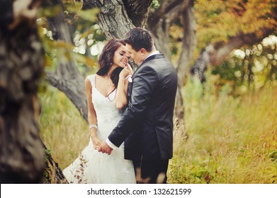 Married Couple in forest embracing