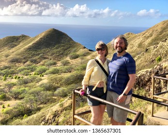 Married couple on vacation hugging and smiling. Diamond Head. Honolulu. Oahu. Hawaii.