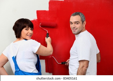 Married Couple Painting Wall