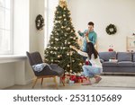 Married couple preparing for Christmas or New Year by decorating a tree at home. They enjoy the festive anticipation and the joy of the holiday season while creating a warm and cheerful atmosphere.