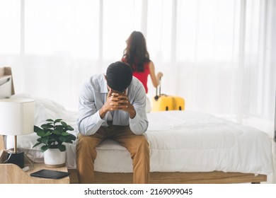 Married couple tired in problem of relationship to divorce concept. Man sad and stress sitting on the bed and blur woman  on background. - Shutterstock ID 2169099045