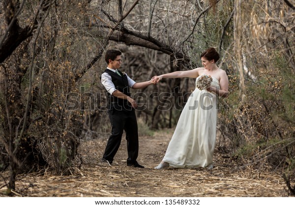 Married Same Sex Couple Dancing In The Forest Together