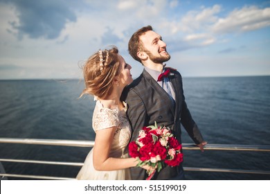 Married Wedding Couple Standing On A Wharf Over The Sea