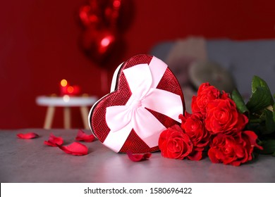 Marry me concept, wedding / engagement ring with red candles, roses bouquet, heart shaped air balloon. Happy st. valentine's day concept. Close up, copy space, front view