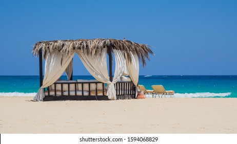 Marsa Matruh, Egypt. Elegant gazebo on the beach. Amazing sea with tropical blue, turquoise and green colors. Relaxing context. Nobody on the beach. Fabulous holidays. Mediterranean Sea. North Africa