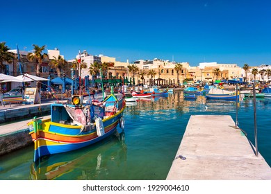 Marsaxlokk, Malta - January 10, 2020: Traditional fishing boats in the Mediterranean Village of Marsaxlokk, Malta