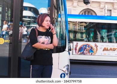 Marseille, France - 09 07 2018: A Middle-aged Woman Of Asian Origin Calls In Front Of A Public Transport Bus Stop At The Bottom Of The Canebière In September 2018.
