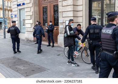 Marseille, France - 23 -11-2021: French Policemen Controls Young Black People In The Streets Behind An Illegal Squat From Illegal Migrants People