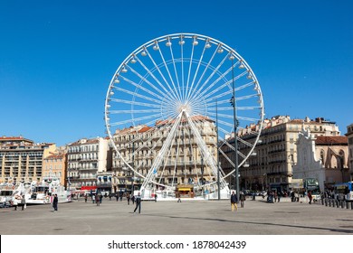 Marseille, France - April 1, 2015: People Enjoy Big Ferris Wheel Against A Blue Sky In Marseille, France.