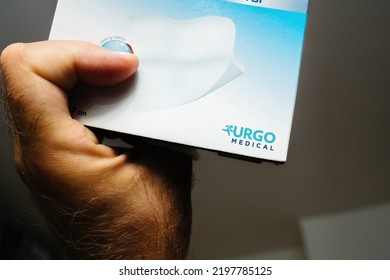 Marseille, France - Jul 16, 2022: POV Male Hand Close-up Holding Package With Urgo Medical - The Division Of Urgo That Offers Advanced Wound Healing Products For Critically Injured Or Burned Patients.