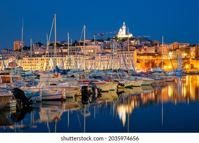 Marseille Old Port (Vieux-Port De Marseille) With Yachts And Basilica Of Notre-Dame De La Garde In The Night. Marseille, France