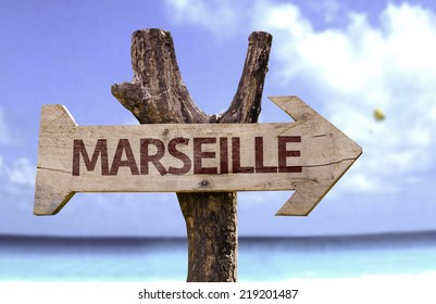 Marseille Wooden Sign With A Beach On Background