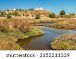 Marsh of Castro Marim and Vila Real de Santo António in Portugal, with the ravelin and the chapel of Santo António in the background, on a sunny day in summer.
