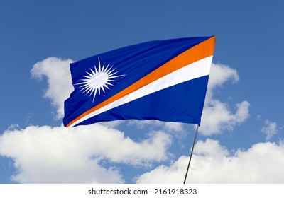 Marshall Islands flag is isolated on the blue sky with a clipping path. flag symbols of Marshall Islands.