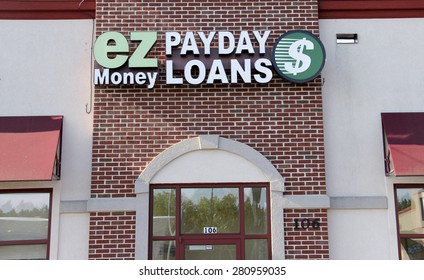 Marshfield Wisconsin, May, 22, 2015  Payday Loans Sign on a building Store Front. Payday Loans is a high interest service providing loans to high risk clients.