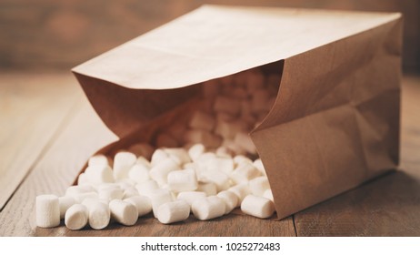 Marshmallow In Brown Craft Paper Bag On Wooden Table