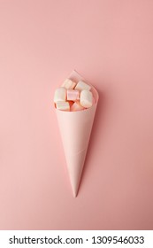 Marshmallow Candy Pastel Color Assortment In Paper Cone On A Pink Background Viewed From Above. Gummy Candy Variation. Top View, Monochrome Summer Concept