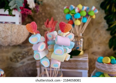 Marshmallow lollipop and gummy kabobs on a wedding party, no people shown