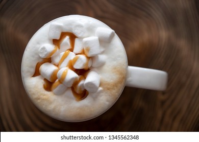 Marshmellow In Coffee On A Wooden Surface