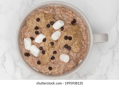 Marshmellows And Chocolate Chips On Top Of Oatmeal Ready To Eat In A Bowl On The Table Is A Great Way To Start The Day With A Good Source Of Fiber And Protein.