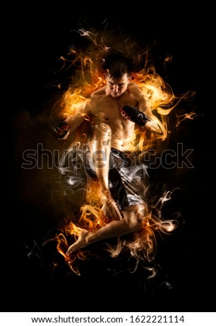 Martial arts fighter (MMA) jumping with a knee kick. Smoke background 