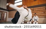 Martial arts, flip demonstration and Japanese sport with learning, exercise and karate etiquette in dojo. Japan, training and fight studio with master, discipline and warrior in taekwondo class