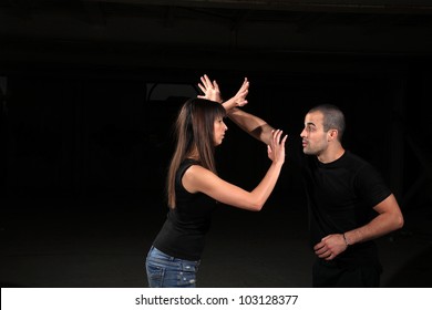 Martial Arts Instructor Exercising With Young Girl