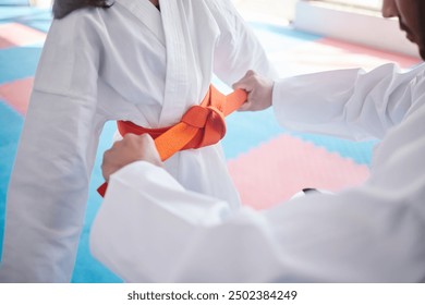 Martial arts, karate and belt in studio for fitness, teaching and respect with support, bow or helping. Sensei, student and celebration as people for self defense class, graduation and discipline - Powered by Shutterstock