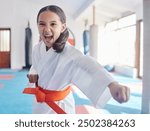 Martial arts, karate and girl in studio for fitness, training and fight with orange belt, shout or energy. Student, kung fu and practice in dojo as workout for self defense, tai chi and taekwondo