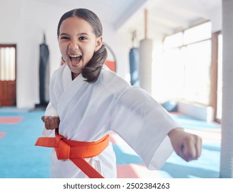 Martial arts, karate and girl in studio for fitness, training and fight with orange belt, shout or energy. Student, kung fu and practice in dojo as workout for self defense, tai chi and taekwondo