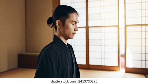 Martial arts man, meditation and training in Japanese dojo with mindfulness, zen or chakra balance in morning. Fighter, mma or karate person with peace, breathing and calm for yoga, wellness or floor - Powered by Shutterstock