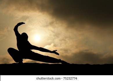 Martial Arts Man Silhouette On Dramatic Sky Background