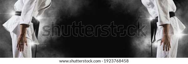 Martial arts masters on dark smoke background.\
Sports banner