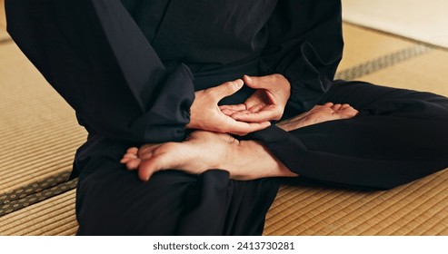 Martial arts person, meditation and floor with hands, feet and peace in dojo with spiritual guide for fight. Yoga, chakra balance and zen exercise for peace, calm or breathe for mma, karate or health - Powered by Shutterstock