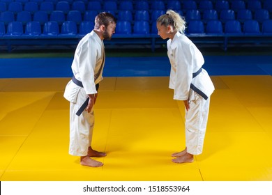 Martial arts. Sparing Portners. Sport man and woman greet each other before a fight in the sports hall - Powered by Shutterstock