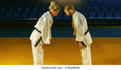 Martial arts. Sparing Portners. Sport man and woman greet each other before a fight in the sports hall - Powered by Shutterstock