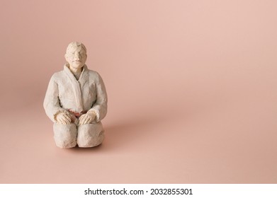 Martial Arts Teacher Setting On Pastel Background. Free Space