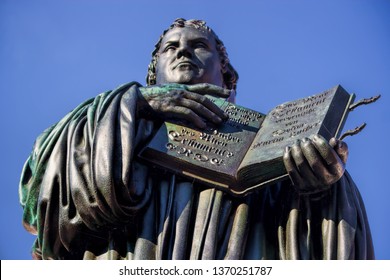 Martin Luther Monument With Bible In Wittenberg, Germany
