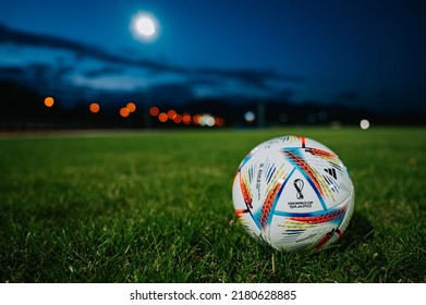 MARTIN, SLOVAKIA, 16 JULY, 2022: Official Adidas Fifa World Cup Football Ball Al Rihla. World Championship In Qatar 2022. Soccer Match Ball On Green Grass In Night At Stadium FIFA 22, Black Edit Space