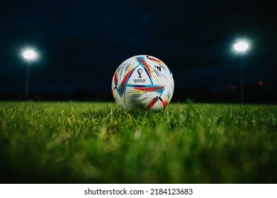 MARTIN, SLOVAKIA, 16 JULY, 2022: Official Adidas Fifa World Cup Football Ball Al Rihla. World Championship In Qatar 2022. Soccer Match Ball On Green Grass In Night At Stadium. FIFA 22, Black Space