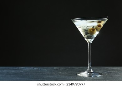 Martini cocktail with ice and olives on grey table against dark background. Space for text - Powered by Shutterstock