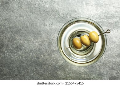 Martini cocktail with olives on grey table, top view. Space for text - Powered by Shutterstock