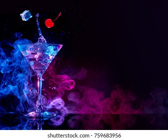 martini cocktail splashing in blue and purple smoky background - Shutterstock ID 759683956