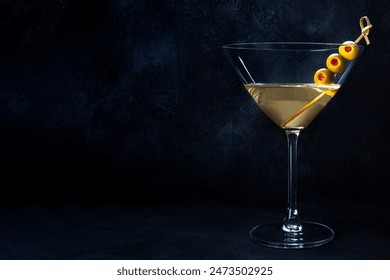 Martini. A glass of dirty martini cocktail with vermouth and olives, aperitif, on a black background, with a place for text - Powered by Shutterstock