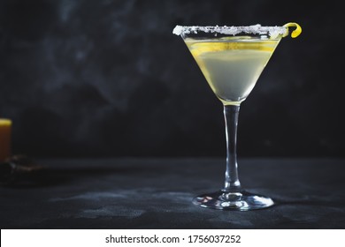 Martini Glass With Lemon And Rim Decorated With Salt. Photos On A Dark Background. Selective Focus.