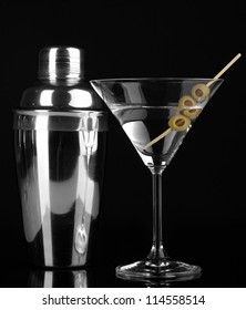 Martini Glass With Olives And Shaker Isolated On Black