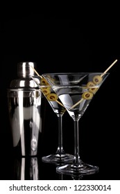 Martini Glass With Olives And Shaker Isolated On Black