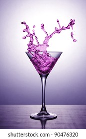 A Martini Glass With Pink Cocktail On Pink Background